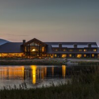 Sage Lodge Montana | Exterior Overlooking Pond at Dusk